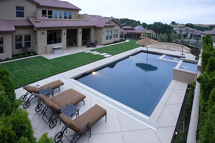 Elegant pool design integrated with beautiful landscaping features.