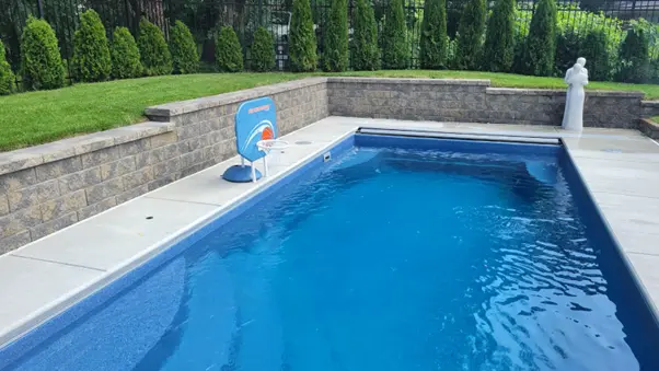 Sparkling clean inground pool with blue water ready for the season, illustrating when to plan your pool opening in Northwest Indiana