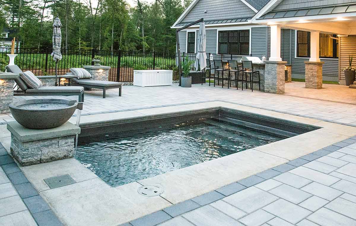 A stunning pool and spa combination design in an Indiana backyard, perfect for relaxation.