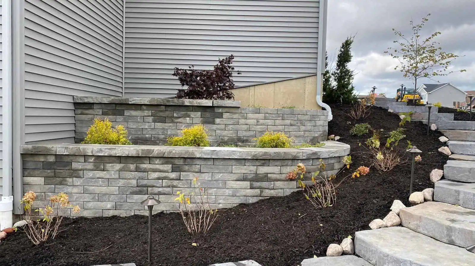 Sophisticated hardscape design with elegant stone pathways and beautiful landscaping.