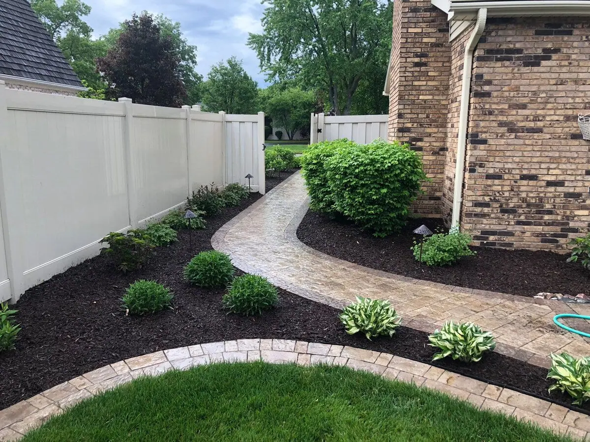 Inviting landscape design showcasing hardscape elements and lush greenery.